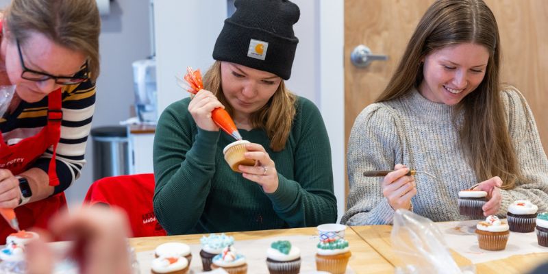 Eternity Team members, Holly, Kalei, and Katie decorating cupcakes at Red Poppy Cakery for an Eternity Team Event.